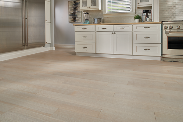 white oak flooring in a kitchen with white cabinets